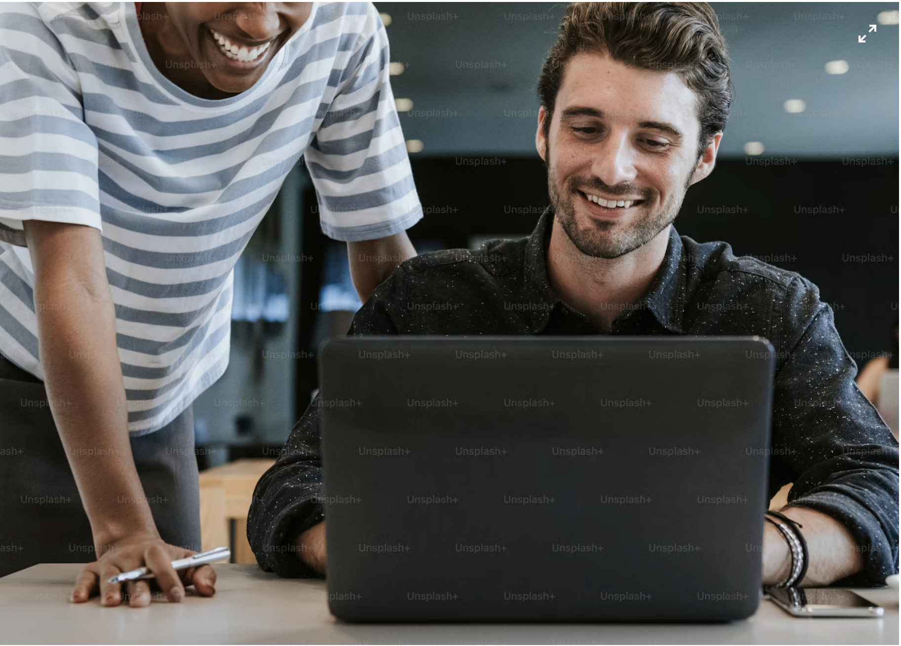 Two colleagues working together at a laptop
